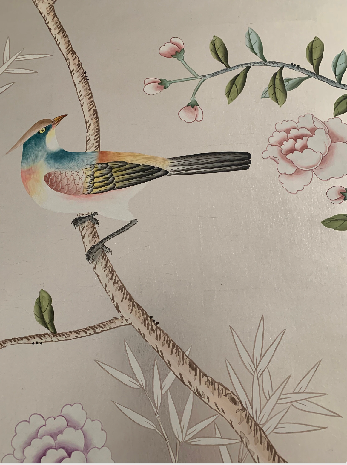 Chinoiserie hand-painted wallpaper mural with birds, trees, and rocks on silver metallic leaf, installed in formal dining room