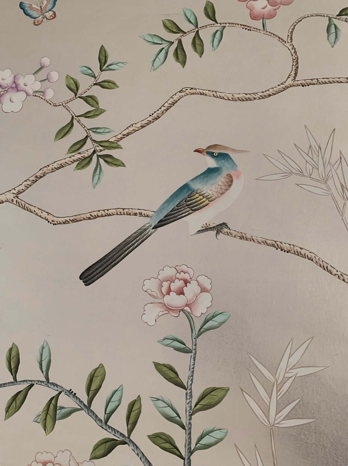 Chinoiserie hand-painted wallpaper mural with birds, trees, and rocks on silver metallic leaf, installed in formal dining room