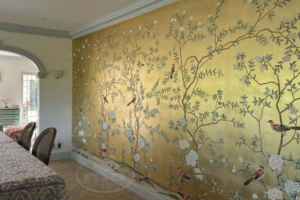 Oriental gold wallpaper mural with songbirds and flowers installed in a luxury dining room
