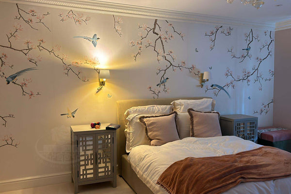 Hand-painted magnolia and bird chinoiserie wallpaper in Japandi-style bedroom on slub silk