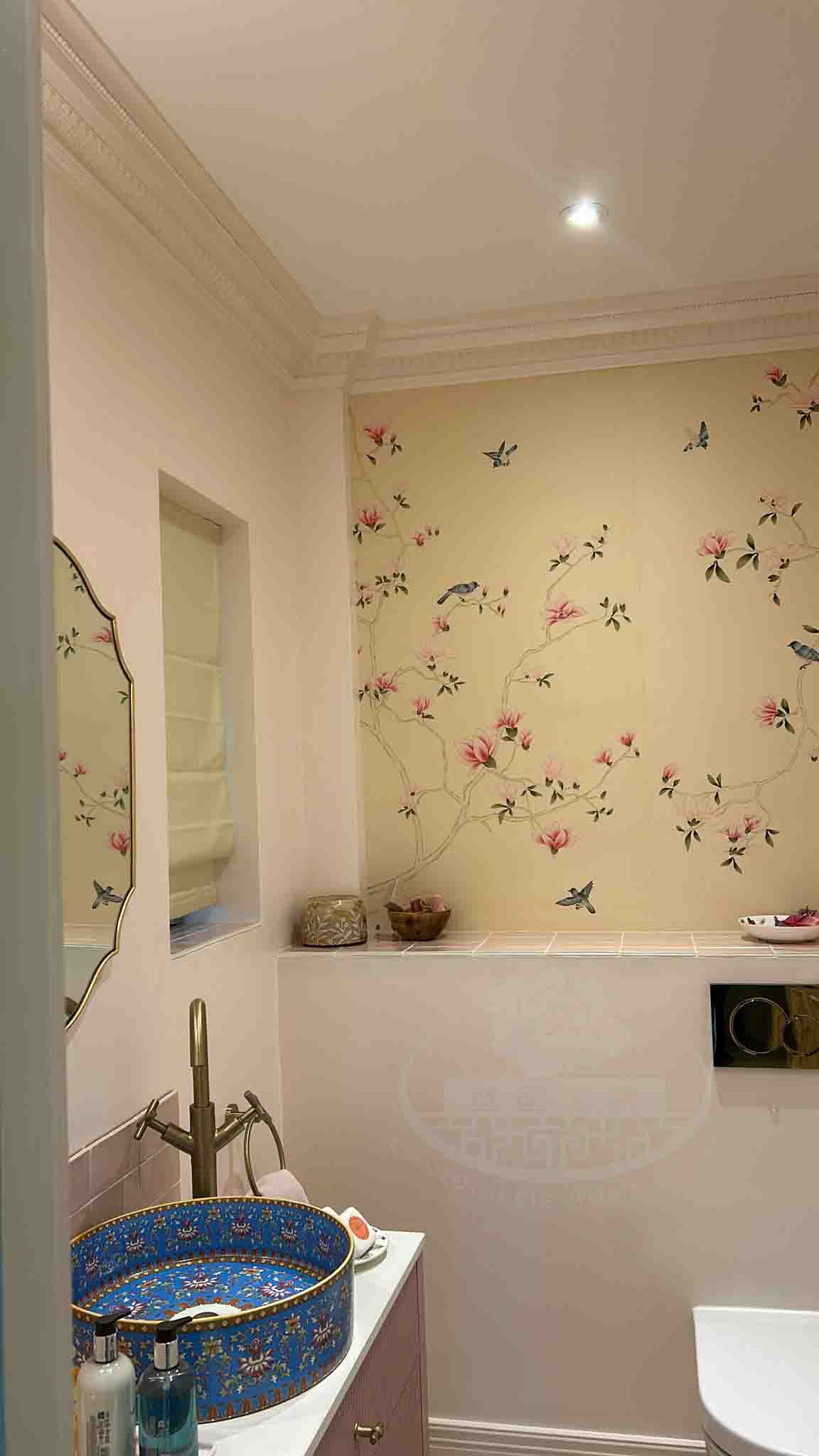 Elegant powder room with chinoiserie hand-painted magnolia mural in pink and ivory tones